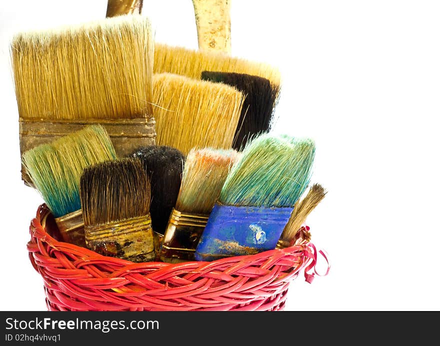 Various used Paintbrushes in a wicker basket