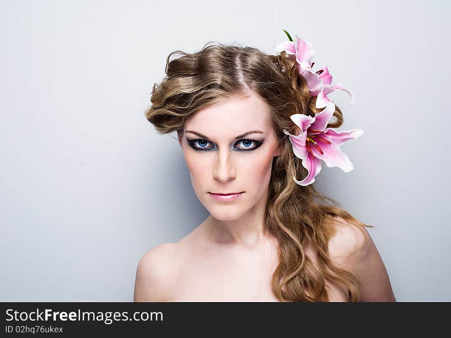 Pretty beautiful woman face with health skin and white lily in her hairs. Pretty beautiful woman face with health skin and white lily in her hairs