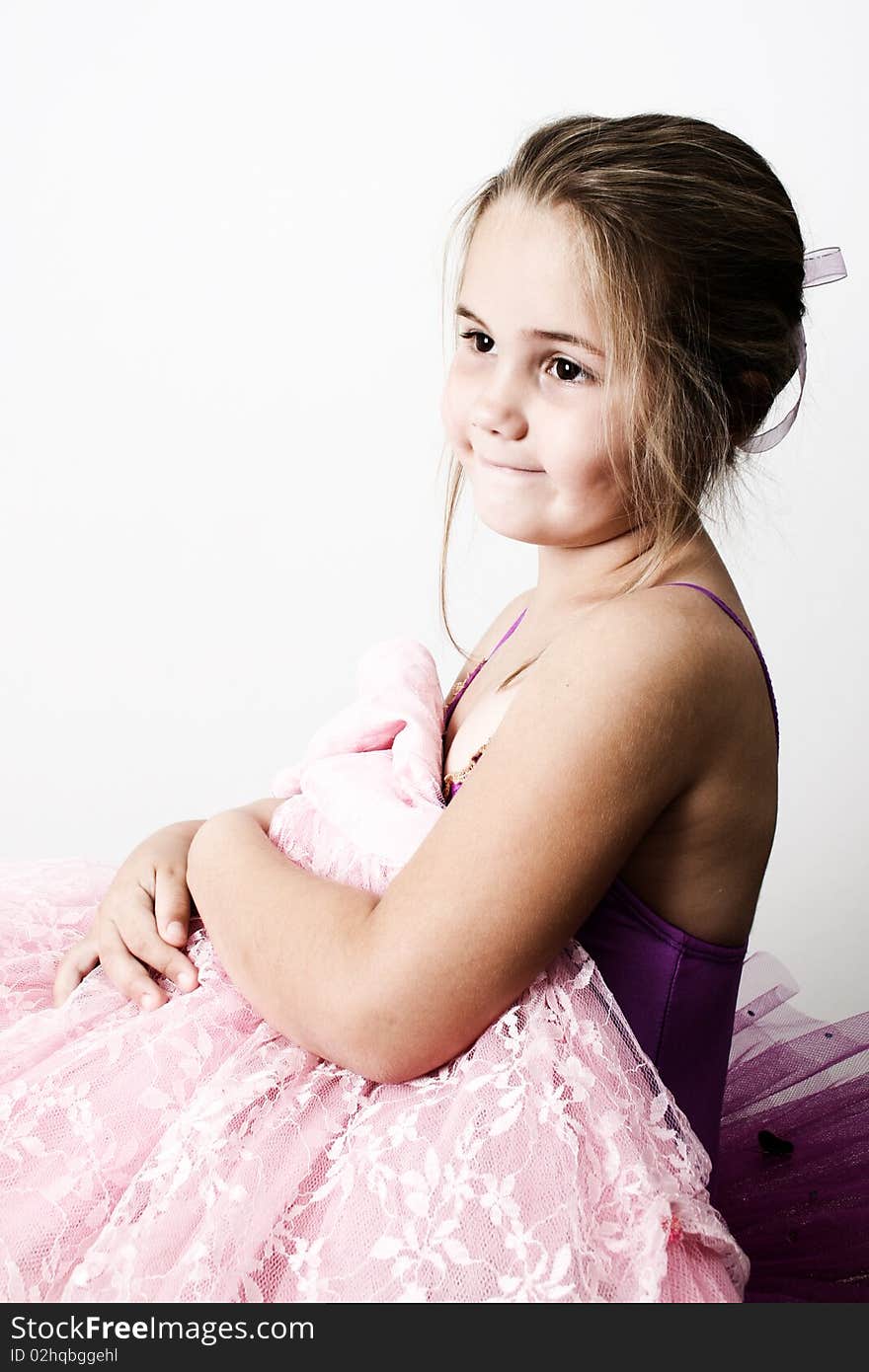 Little ballet girl dressed in a tutu, holding a costume. Little ballet girl dressed in a tutu, holding a costume