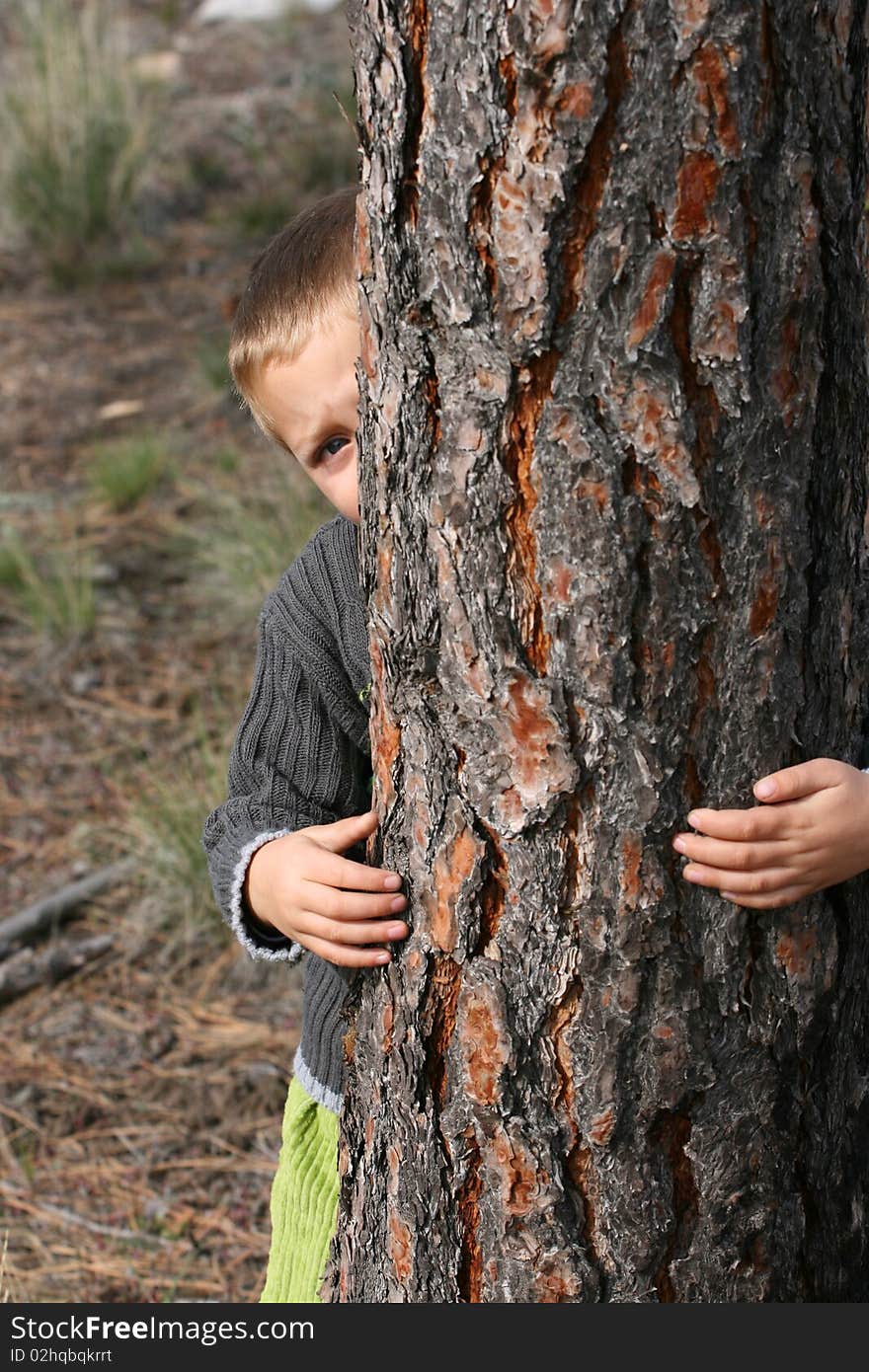 Beautiful blond boy playing outdoors on a spring day