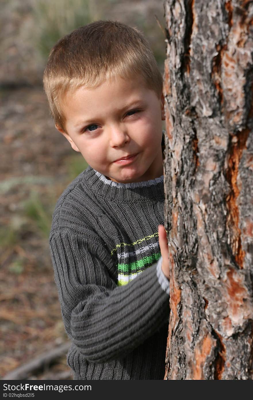 Beautiful blond boy playing outdoors on a spring day