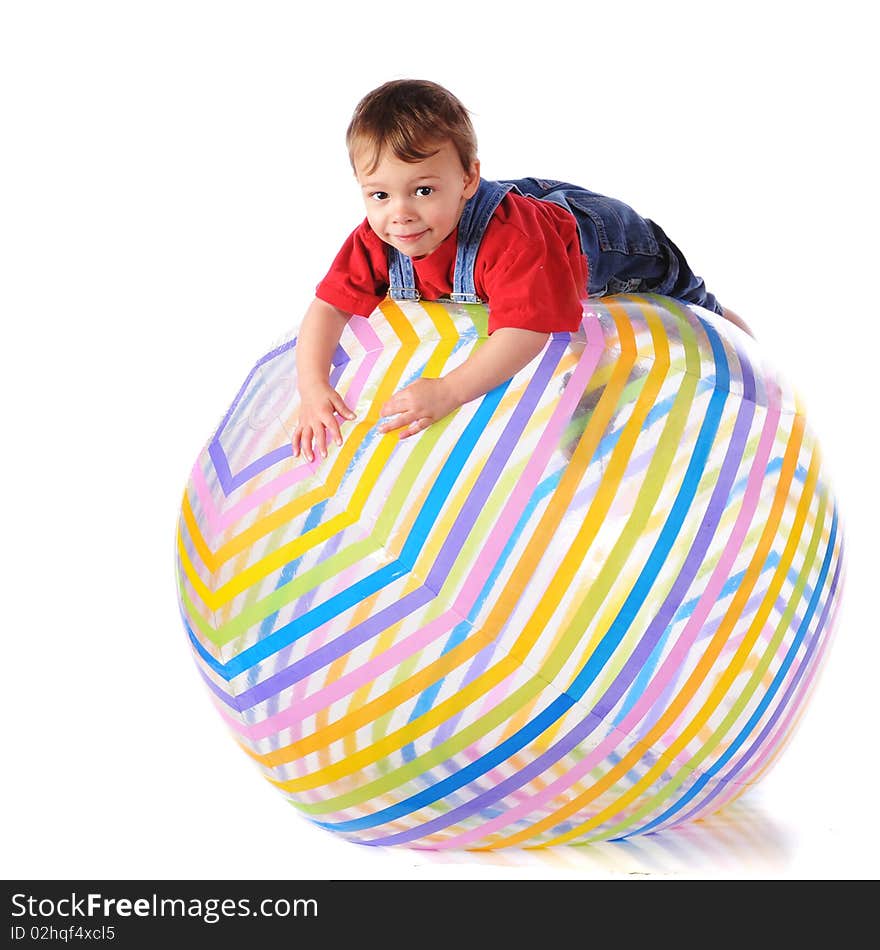 A two-year-old balanced over the top of a giant beach ball.  Isolated on white. A two-year-old balanced over the top of a giant beach ball.  Isolated on white.