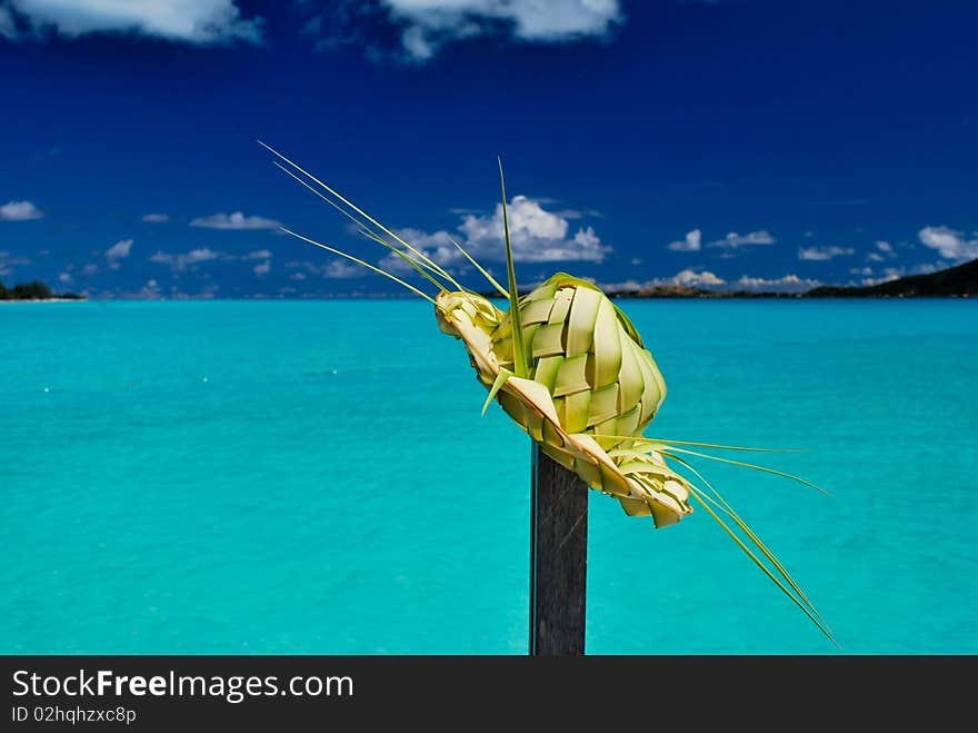 Palm hat against a turquoise blue lagoon in Bora Bora. Palm hat against a turquoise blue lagoon in Bora Bora