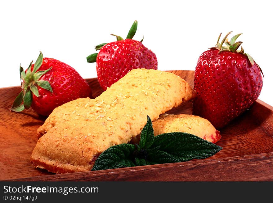 Light meal with fruit - Cereal Bar on a wood plate.