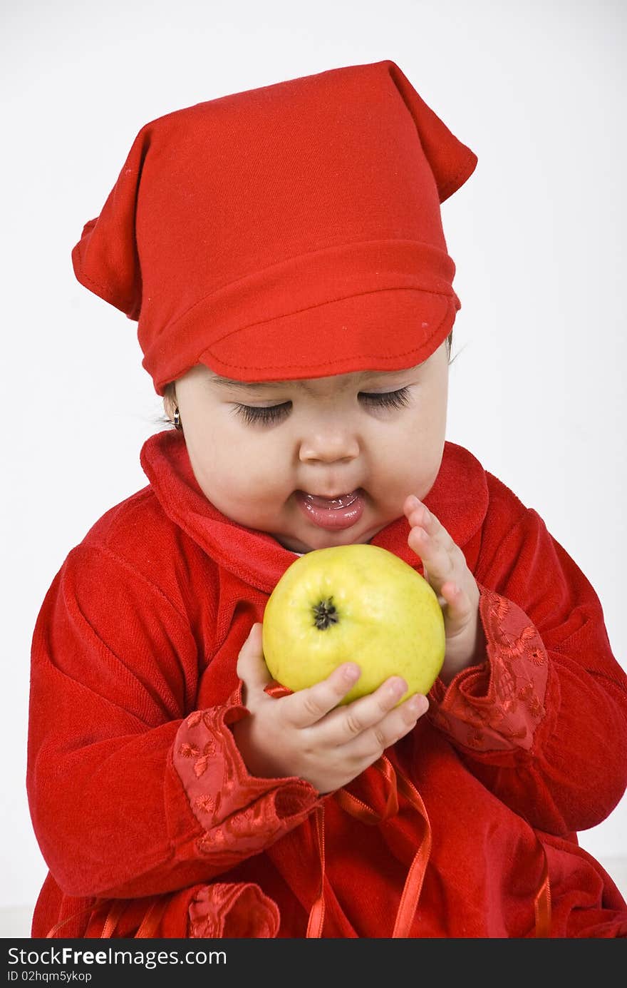 Baby girl holding and caress an apple