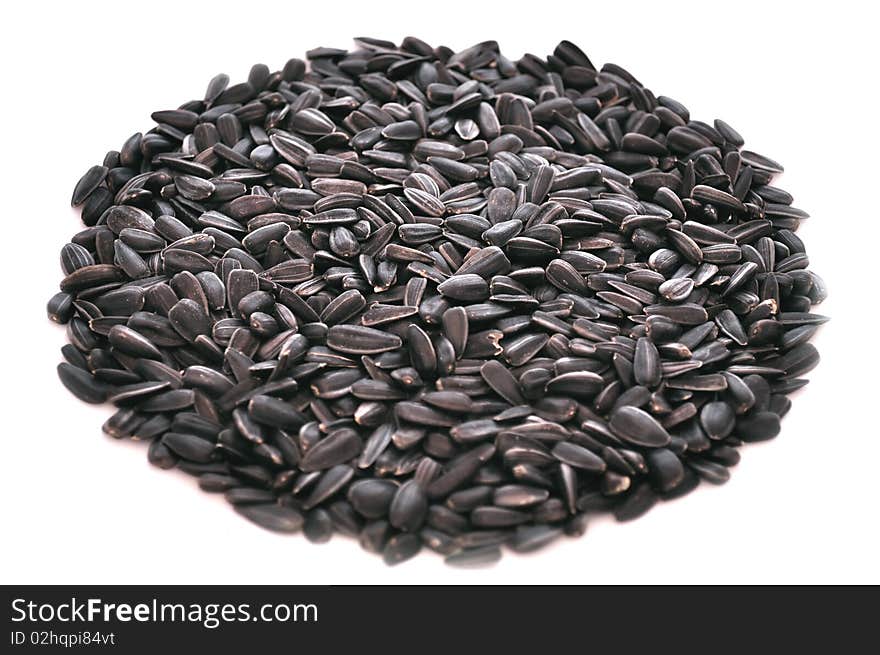 Unpeeled sunflower seeds isolated on a white background