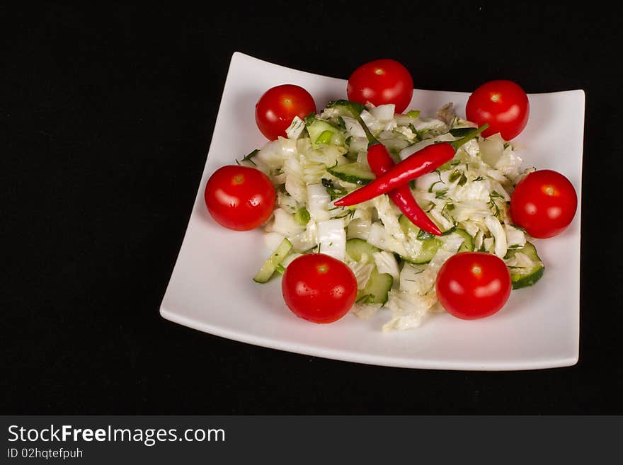 Salad with fresh cabbage, tomato, chilli, cucumber .