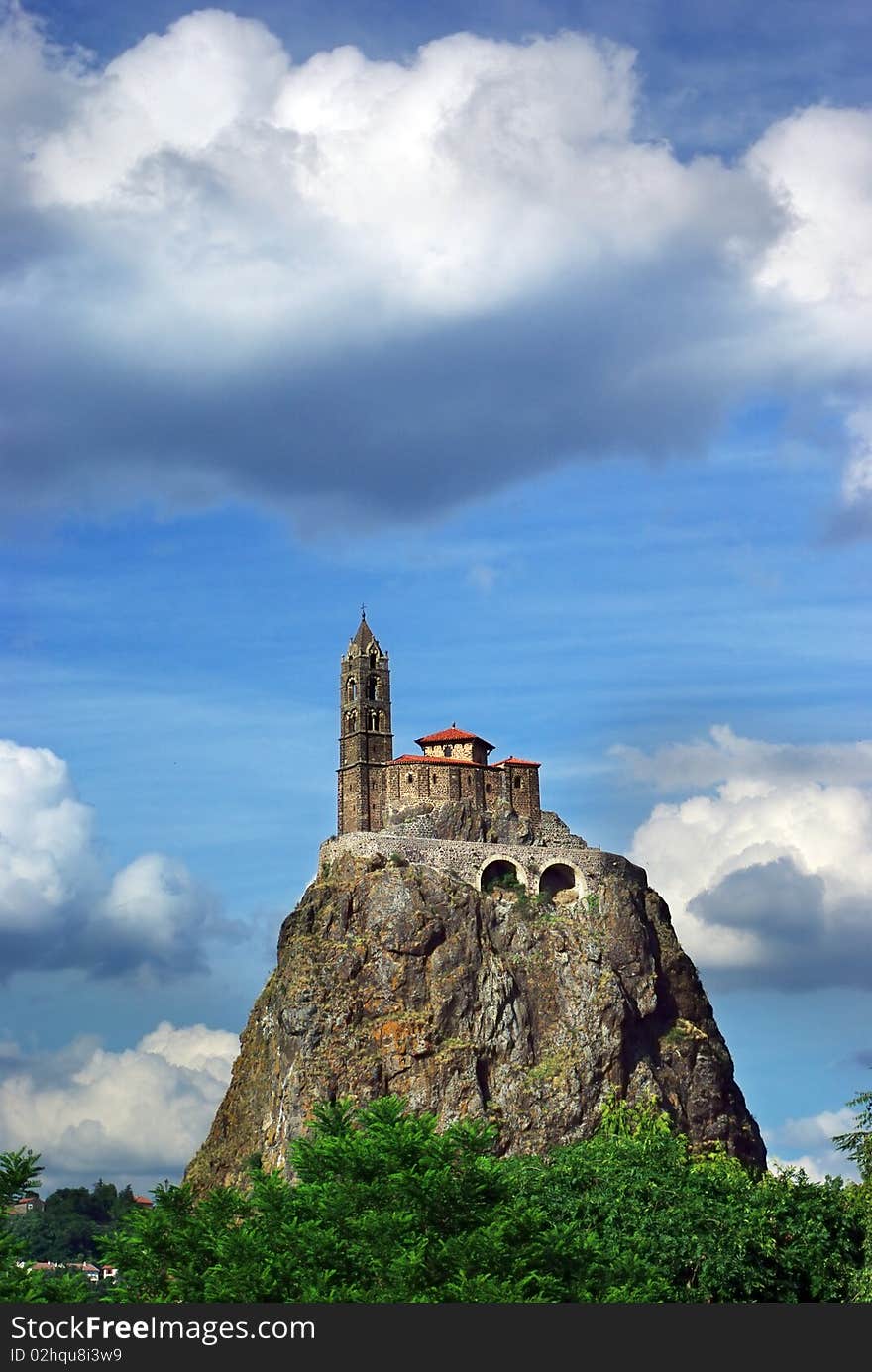 Temple on the hill on the background of the blue sky.   Le Pyui, France. Temple on the hill on the background of the blue sky.   Le Pyui, France