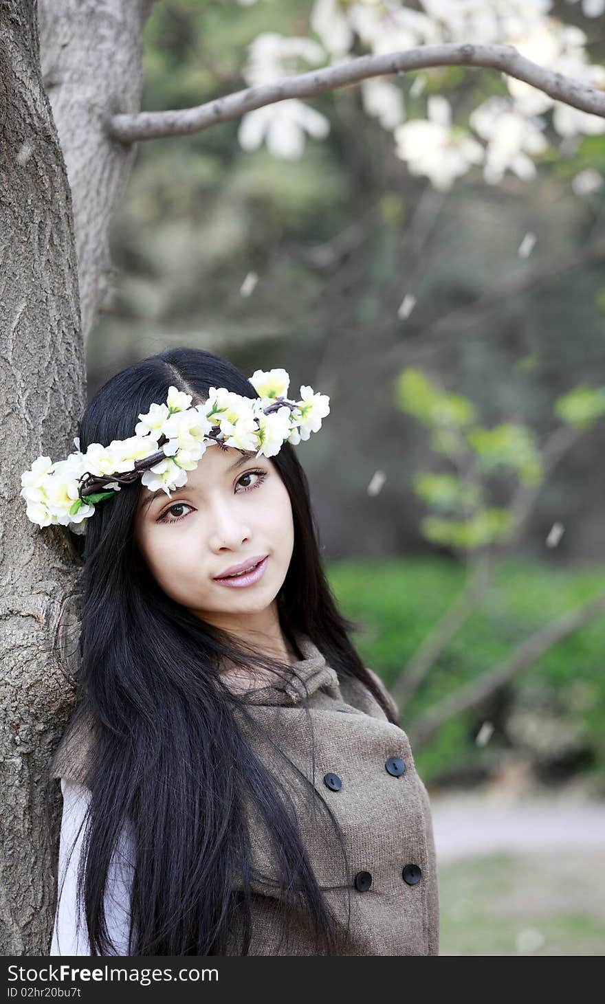 Beautiful Chinese girl holding garlands under cherry tree. Beautiful Chinese girl holding garlands under cherry tree.