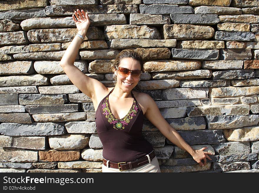 Beautiful Colombian woman with a brick wall background