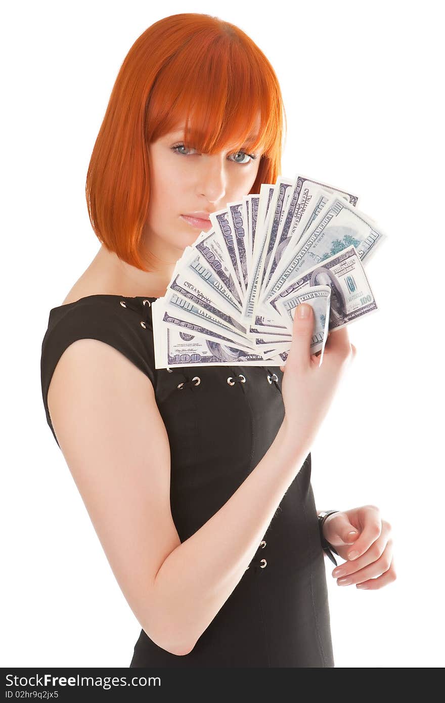 Beautiful red girl with a pack of dollars in a hand