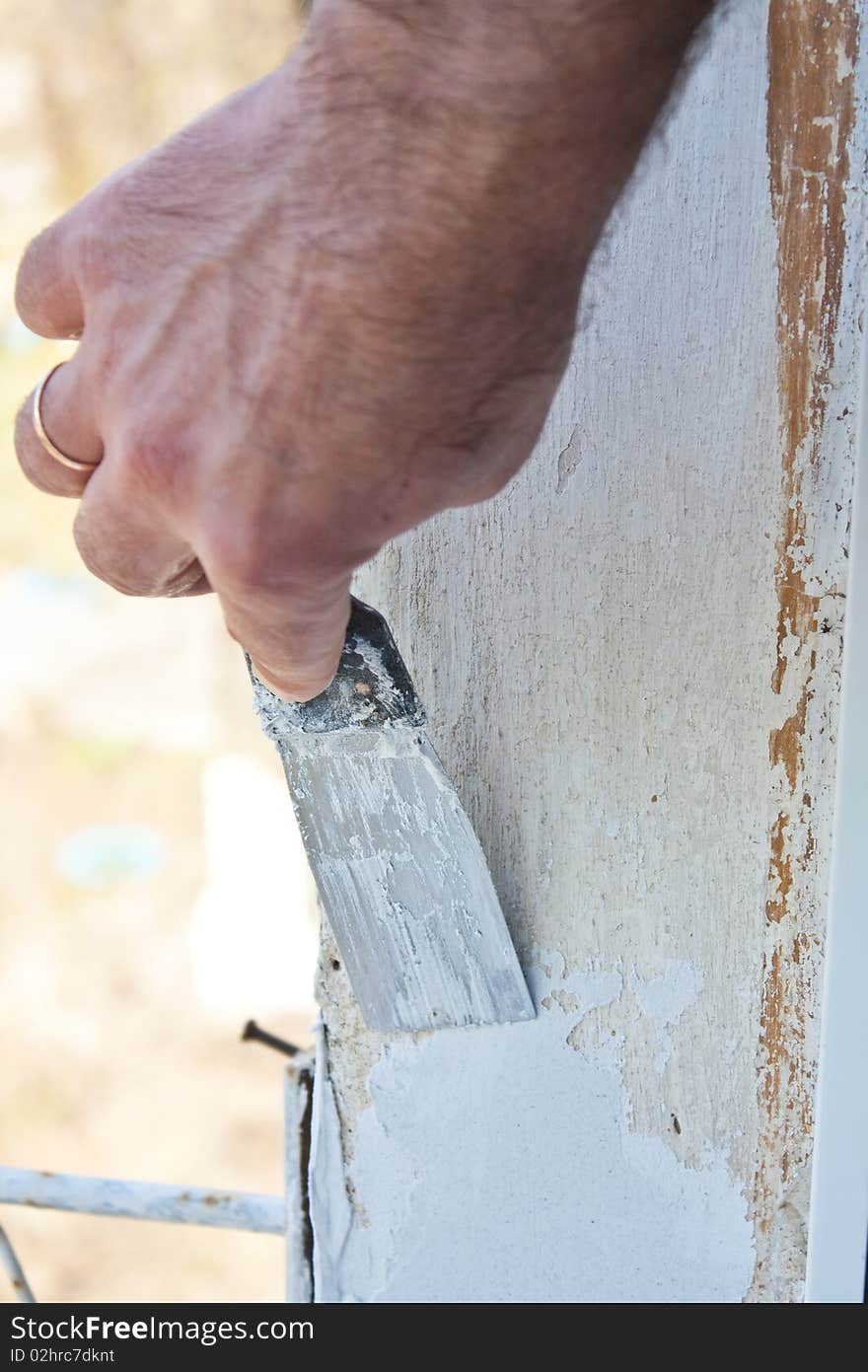 Puttying of a wall by a hand with spatula, repair work