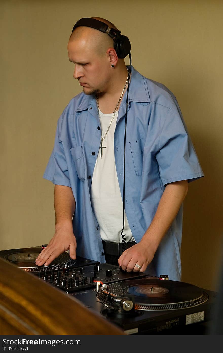 Deejay mixing vinyl records on a turntable players. Deejay mixing vinyl records on a turntable players