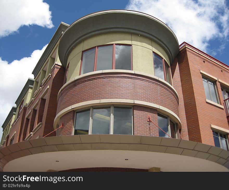 A very unique and asymmetrical design are shown off against the bright blue and white puffy clouds of the sky in Boulder Col. A very unique and asymmetrical design are shown off against the bright blue and white puffy clouds of the sky in Boulder Col