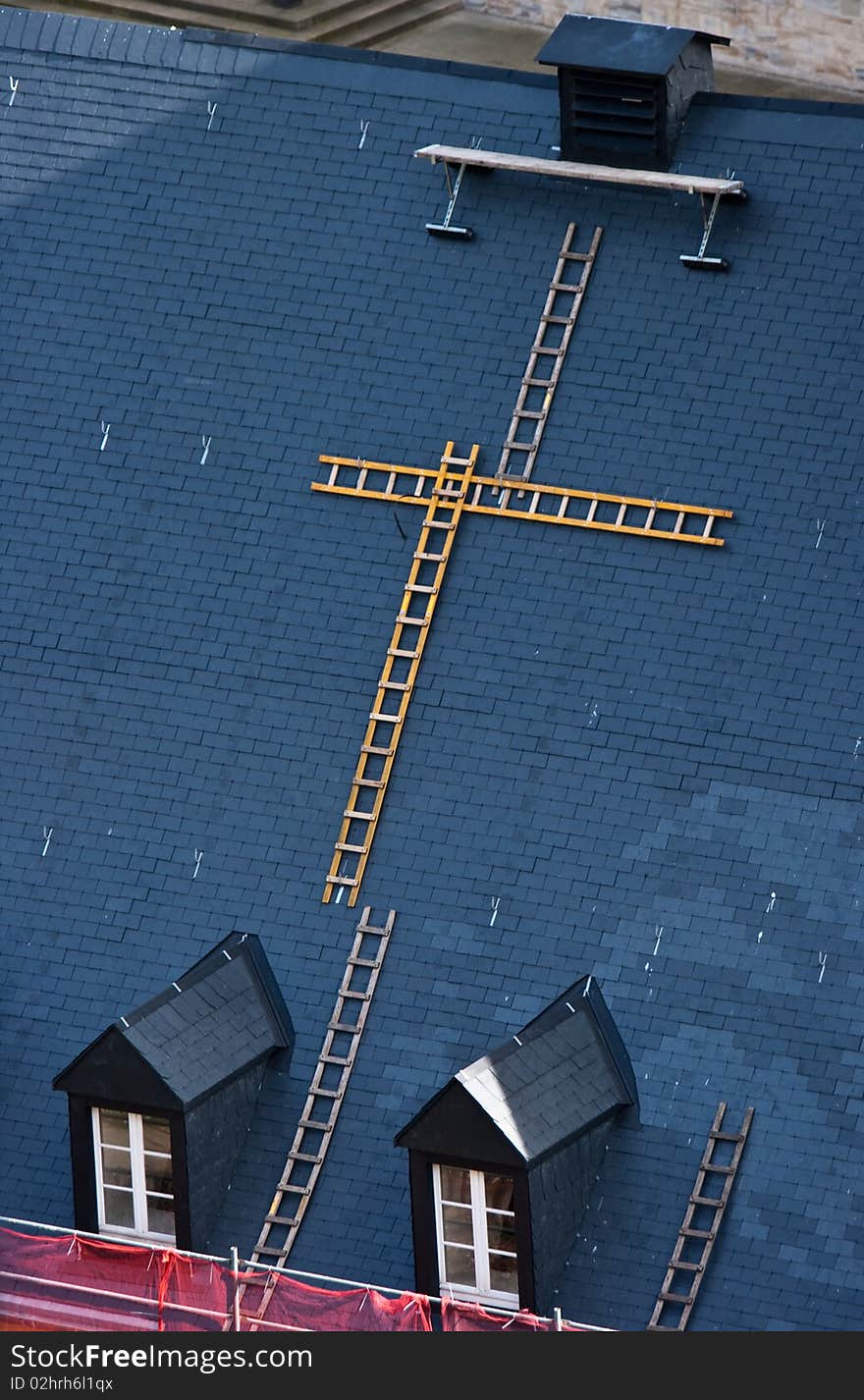 Lots of ladders built up over a roof for maintainance. Lots of ladders built up over a roof for maintainance