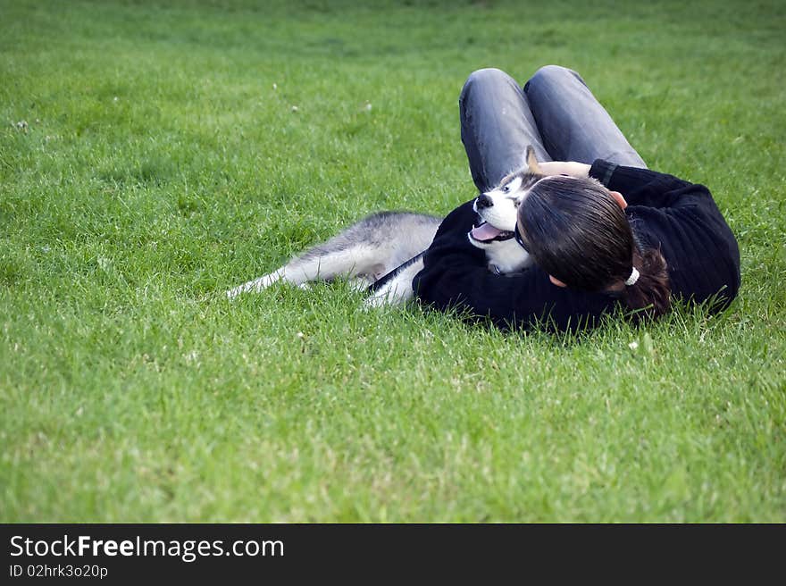 A boy play with his dog in greeen garden. A boy play with his dog in greeen garden