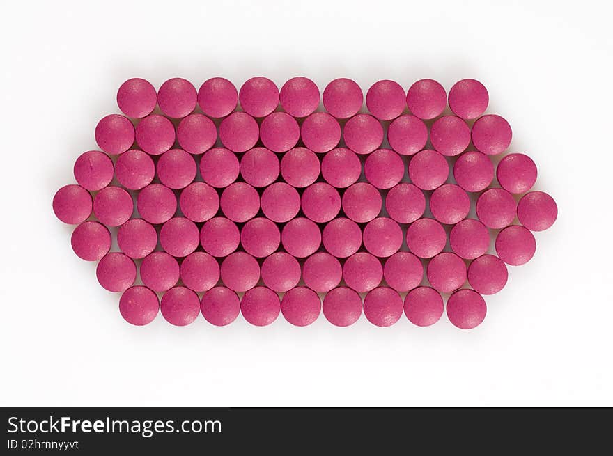 Magenta pills on a white background