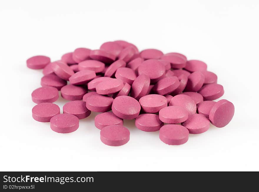 Magenta pills on a white background