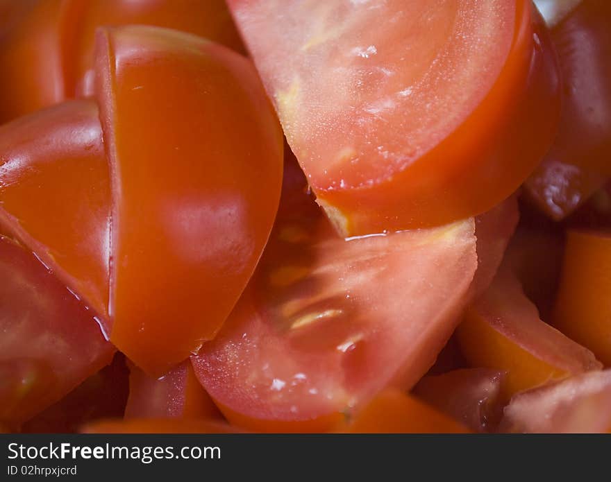 Fresh tomatoes sliced and mixed creating a nice food-themed background. Fresh tomatoes sliced and mixed creating a nice food-themed background.