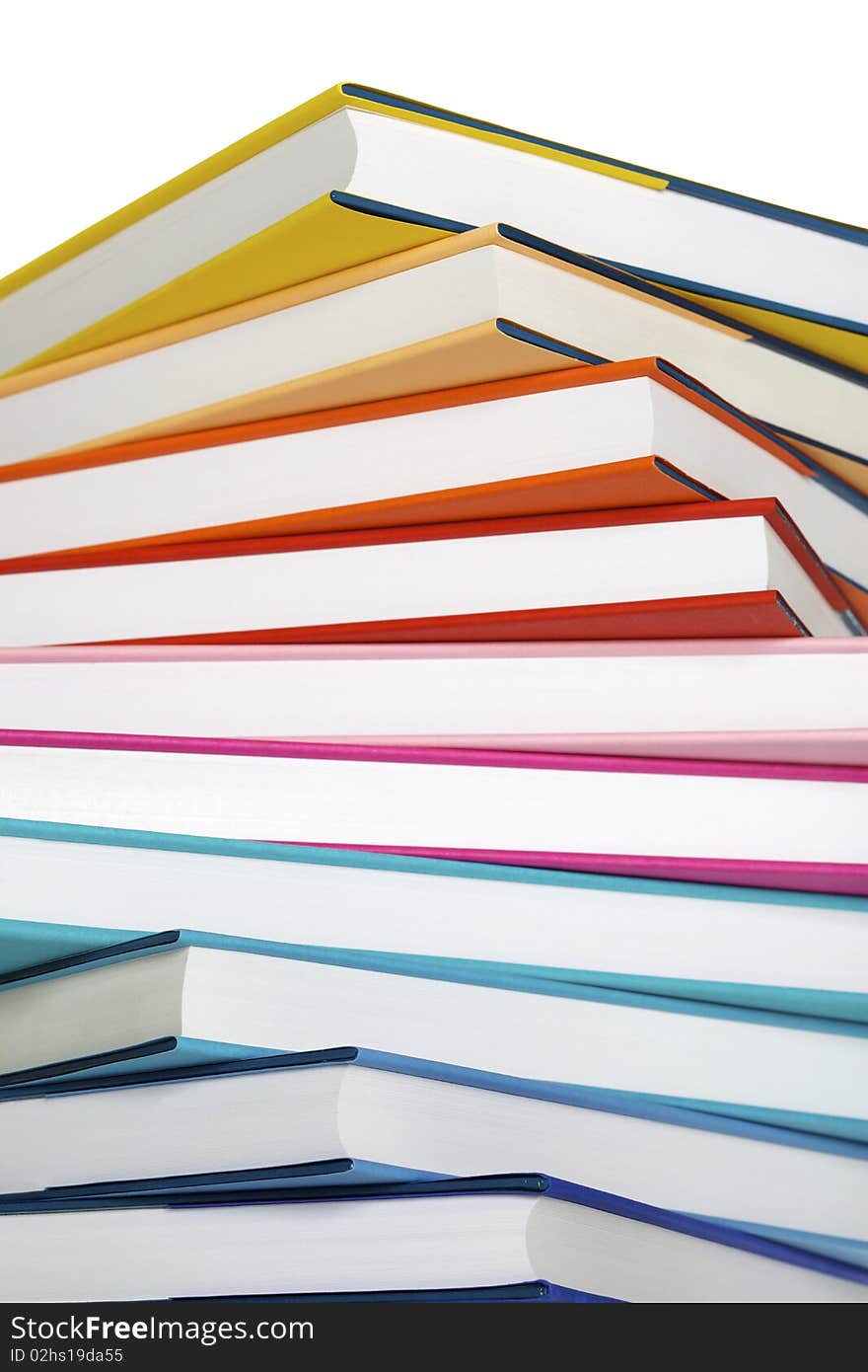 Macro of winding stack of colorful real books on white background. Macro of winding stack of colorful real books on white background.