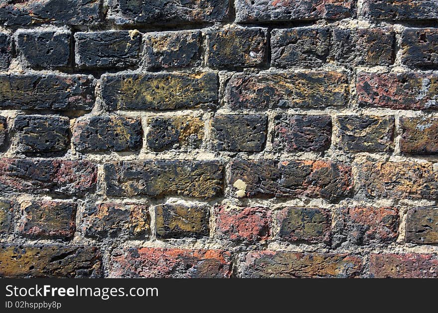 Red and black painted thick brick wall