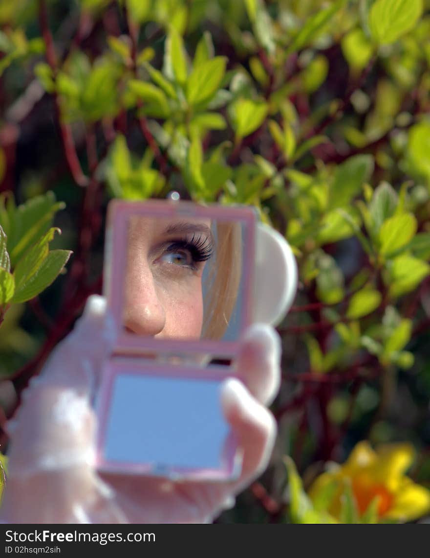 A woman's eye in the compact mirror. A woman's eye in the compact mirror