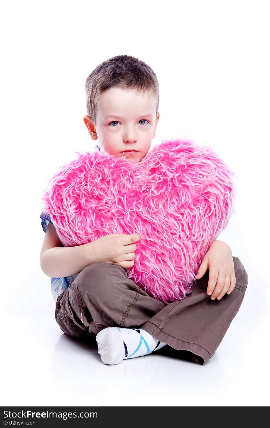 Cute baby boy holding a heart-fur and pink