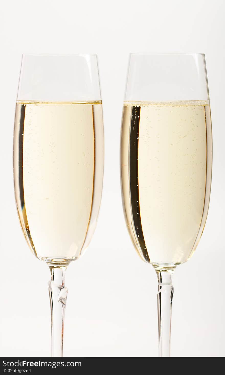 Two flutes with champagne isolated on white background. Two flutes with champagne isolated on white background