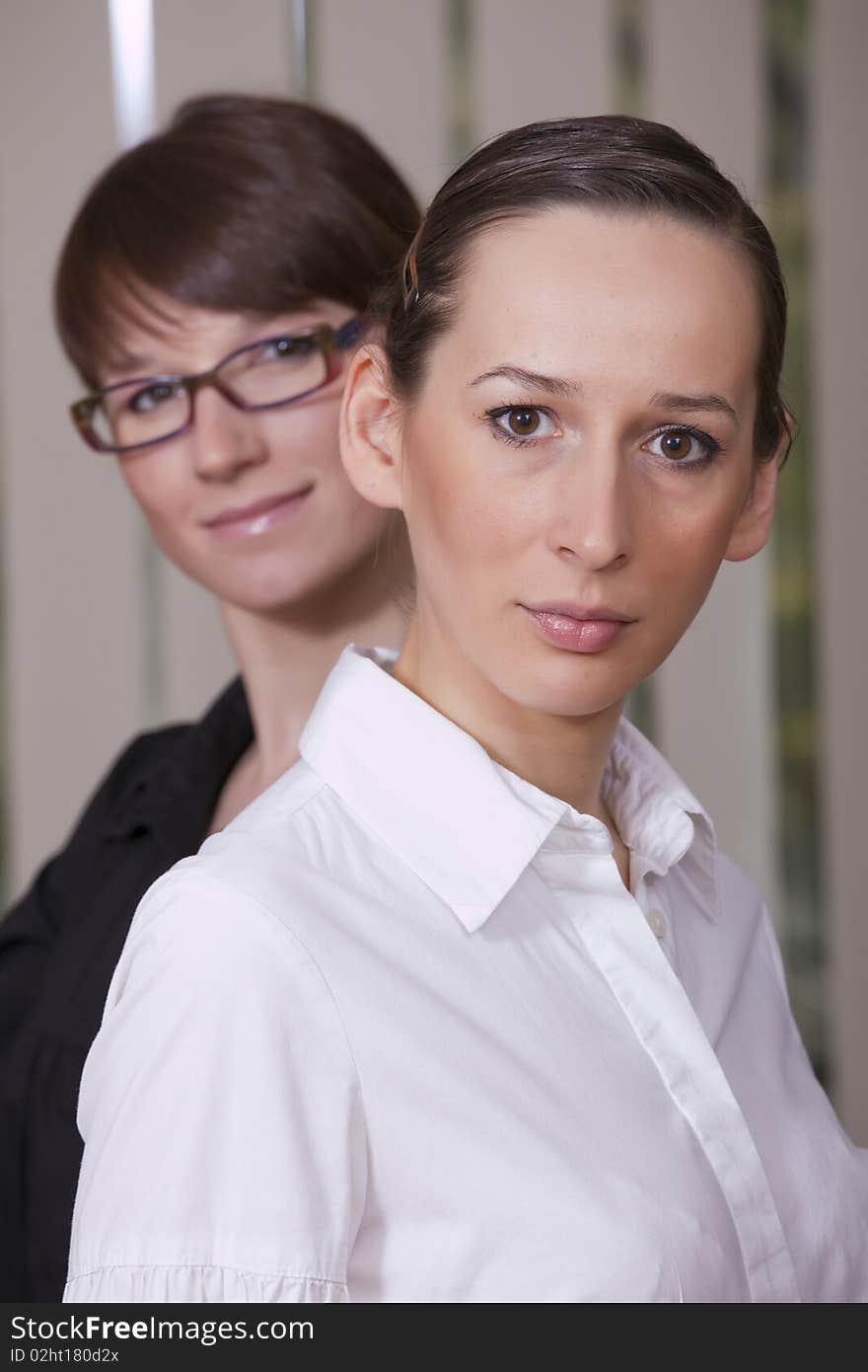 Portrait of two happy businesswomen in a office