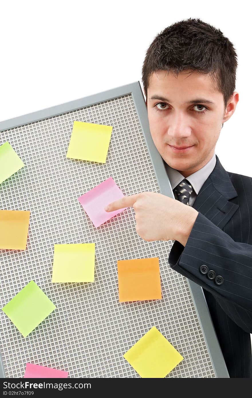 A businessman holding a reminder board with plenty of colorful post-it on it. A businessman holding a reminder board with plenty of colorful post-it on it