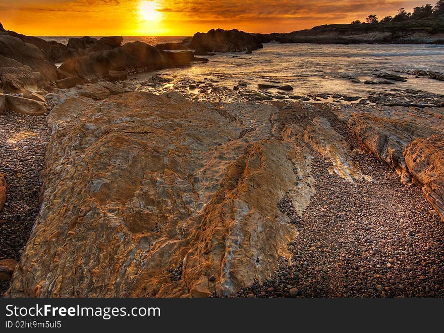 All the colorful details in the rocks appear as the sun sets over a California beach. All the colorful details in the rocks appear as the sun sets over a California beach