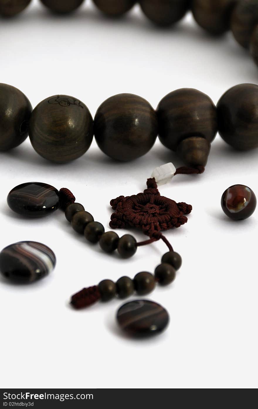 A string of wooden beads and agates ball