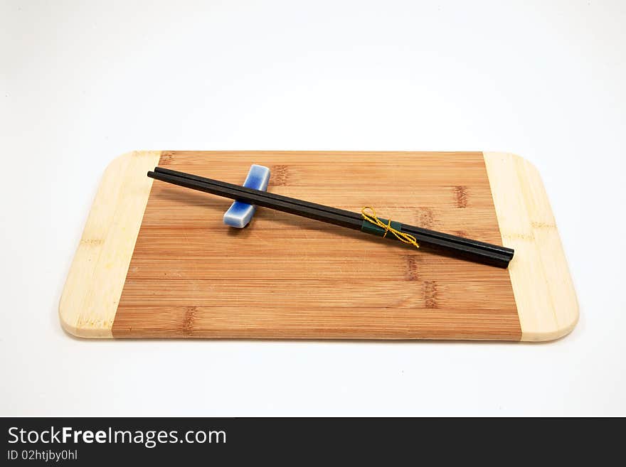 Sushi chopsticks on bamboo cutting board