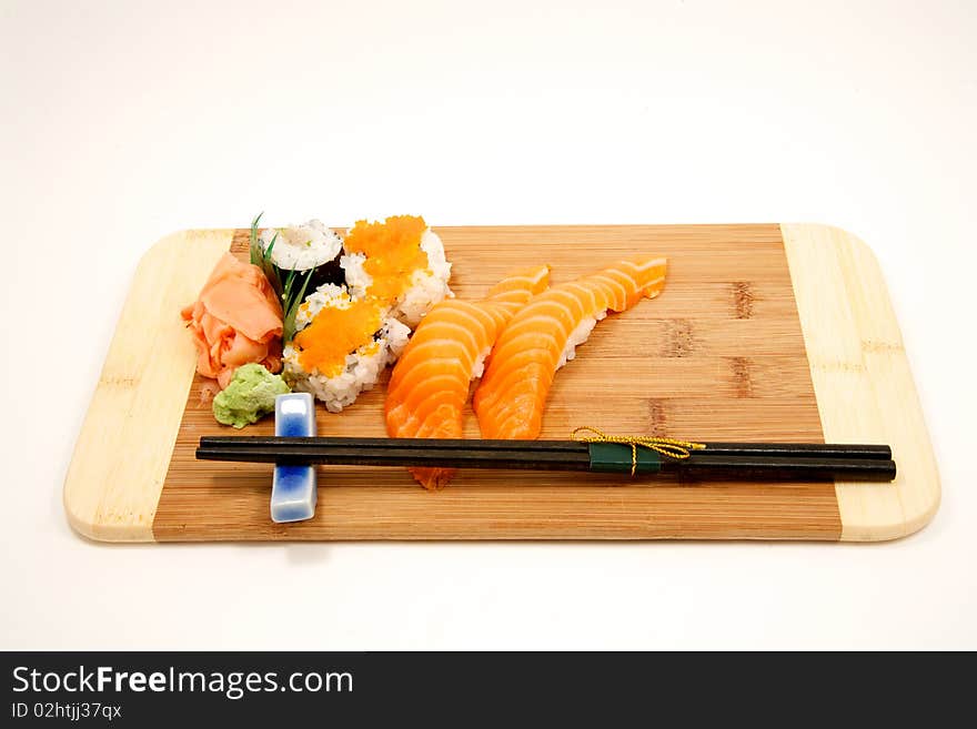 Fresh sushi on cutting board with chop sticks. Fresh sushi on cutting board with chop sticks