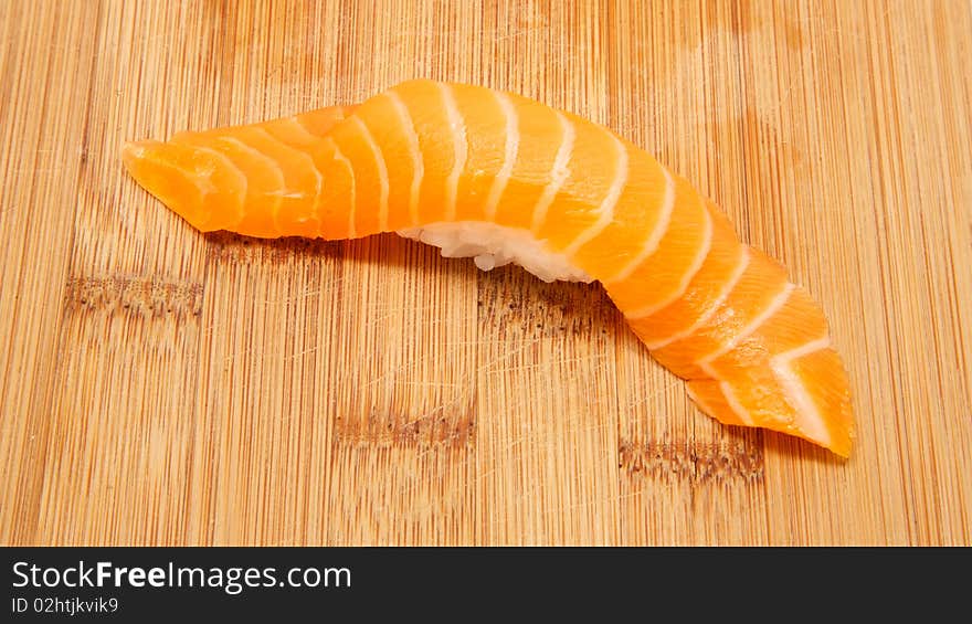 Fresh salmon nigiri on bamboo board