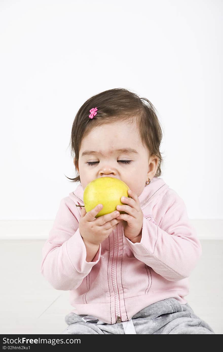 Baby girl bite an apple and enjoying with eyes closed ,copy space for text message.Check also Children. Baby girl bite an apple and enjoying with eyes closed ,copy space for text message.Check also Children