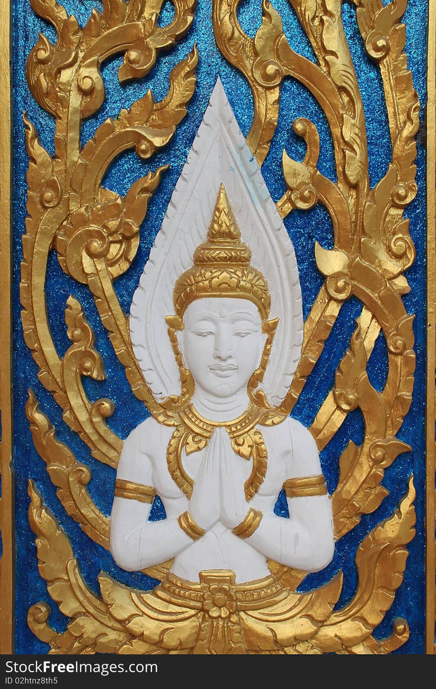 Carving on the door in front of Stupa, North-East Thailand