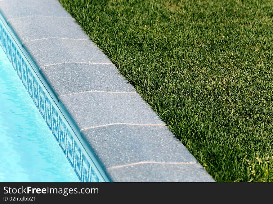 Border between pool and a lawn in an aquapark