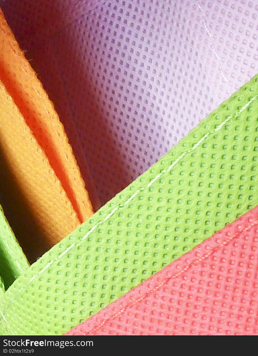 Closeup of texture on coloured shopping bags. Closeup of texture on coloured shopping bags