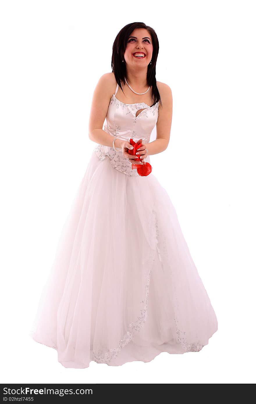 Smiling bride throws rose petals isolated over white background