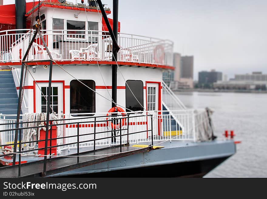 The bow of a white ferry boat in red trim.