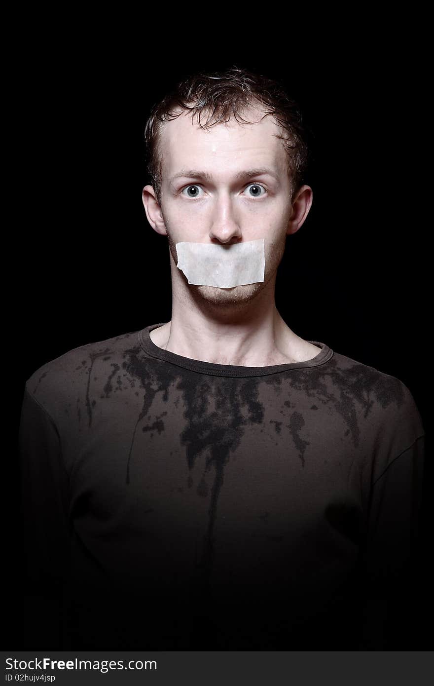 Portrait of hostage on black background