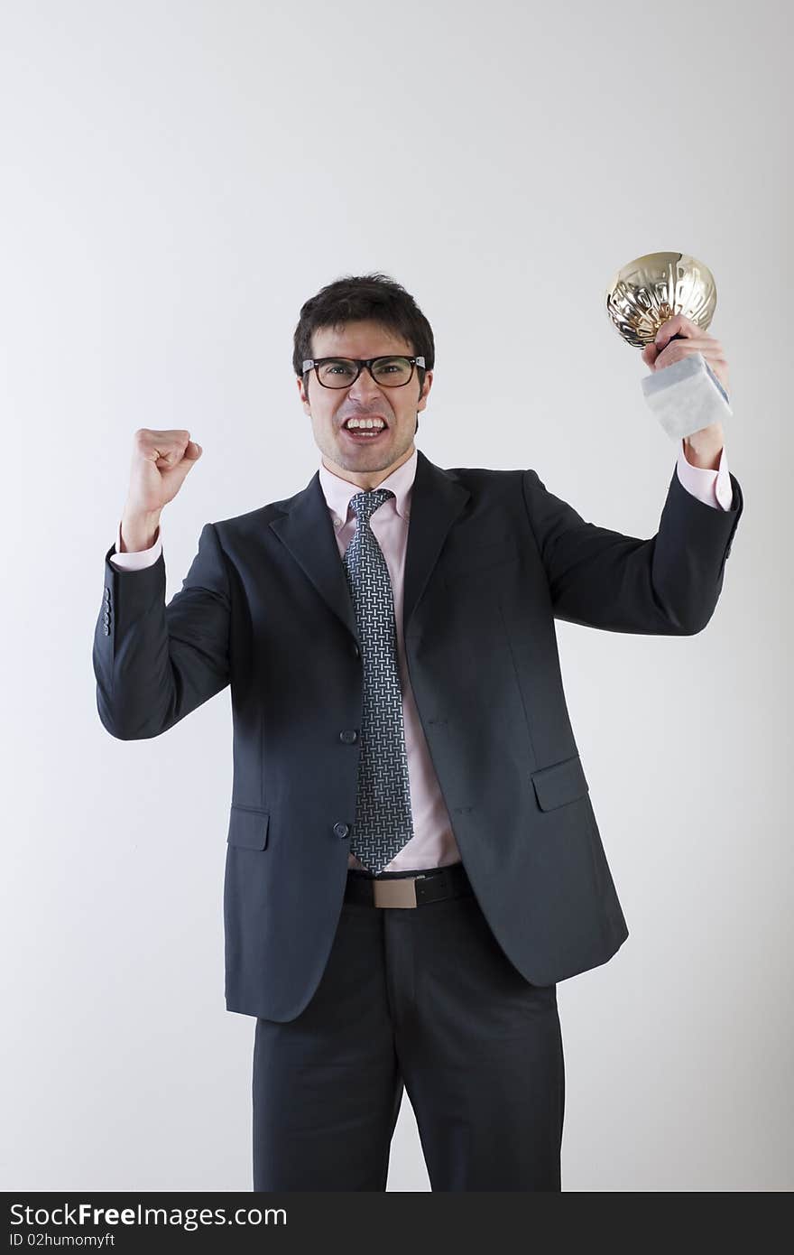 Businessman celebrating raising a cup. Concept: winning the challenge/emerging