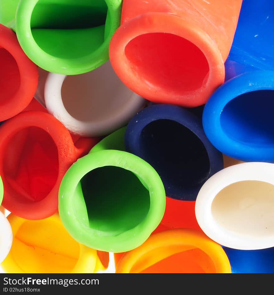 Detail of a stack of balloons, differently colored and uninflated