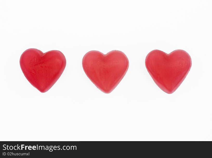 Red and white love heart sweets on a white background