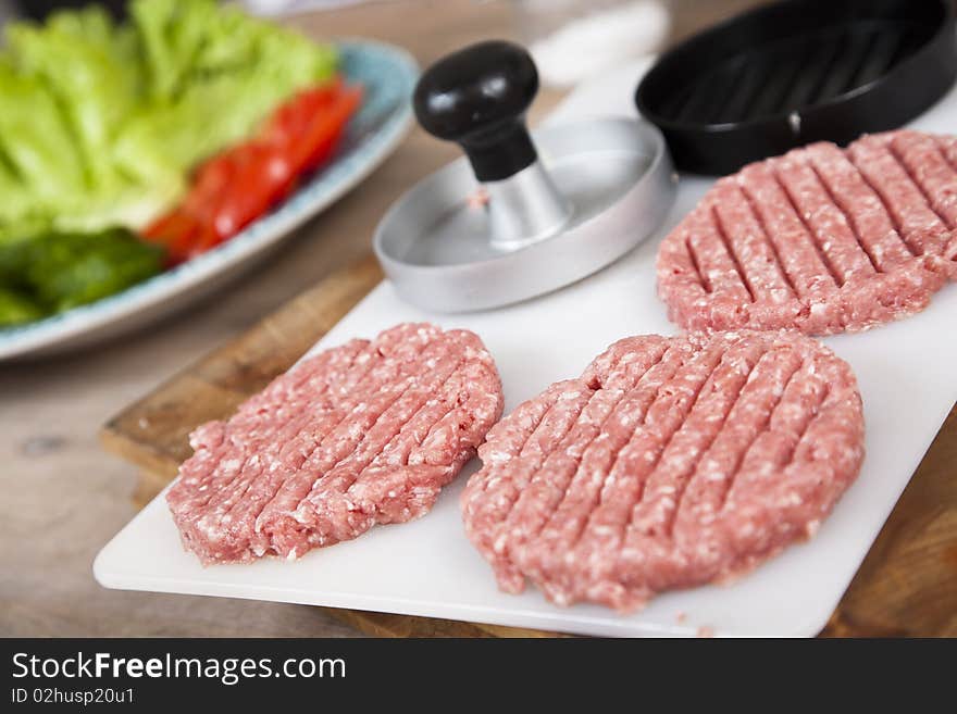 Fresh, homemade hamburgers waiting to be cooked. Shallow d o f. Fresh, homemade hamburgers waiting to be cooked. Shallow d o f