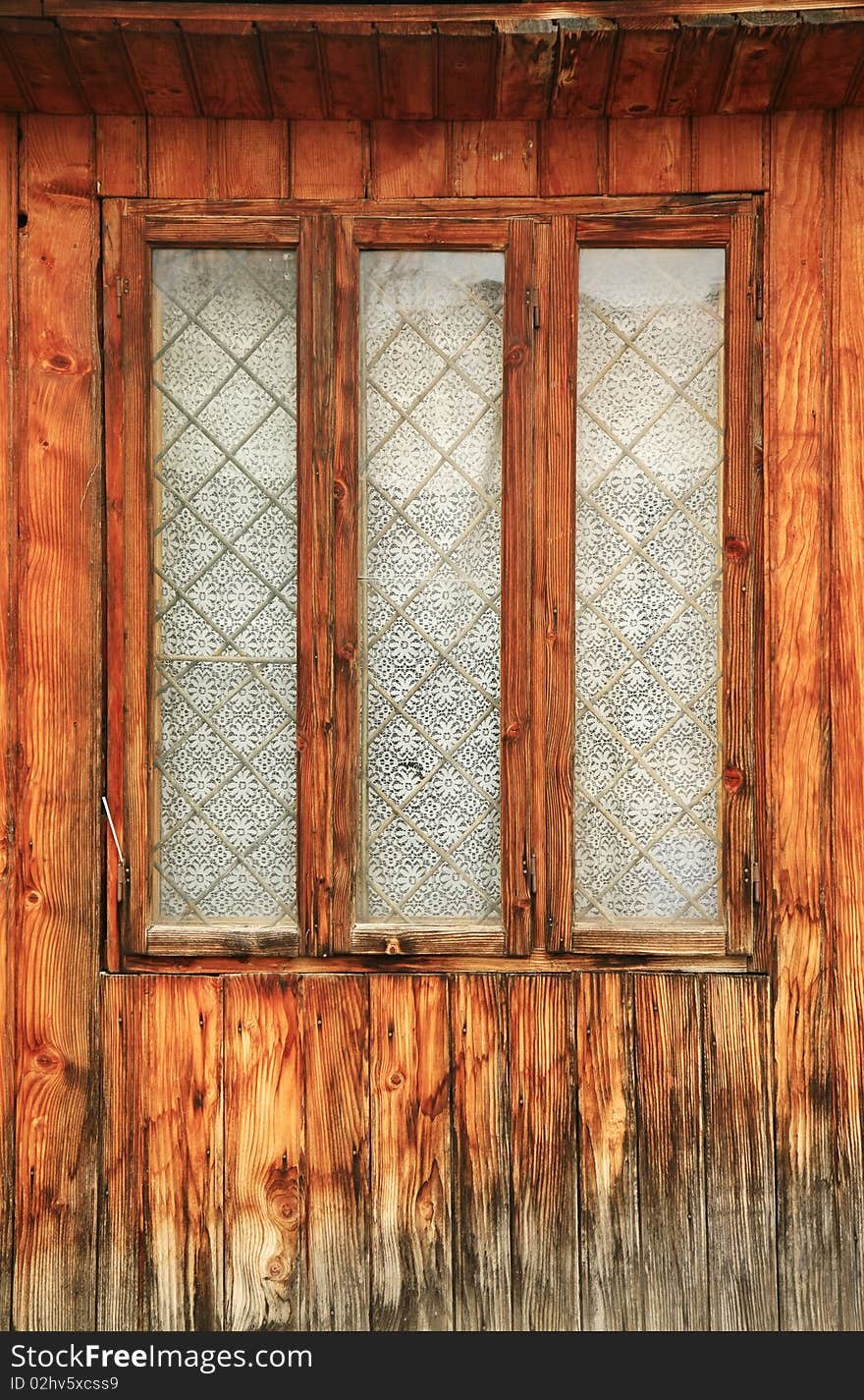 Old romanian wooden window with wall texture. vertical view. Old romanian wooden window with wall texture. vertical view