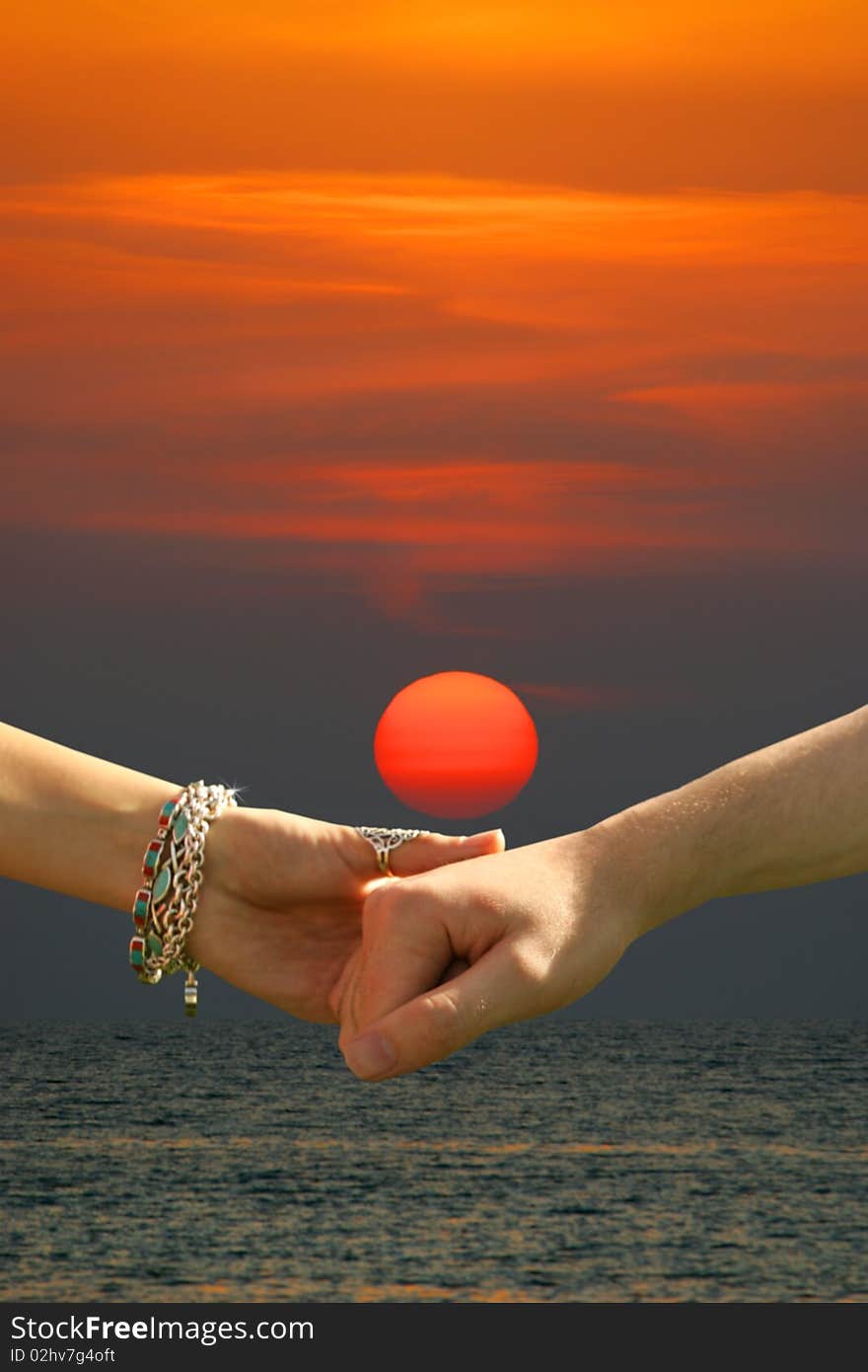 Young lovers holding hands before a Mediterranean Sunset. Young lovers holding hands before a Mediterranean Sunset