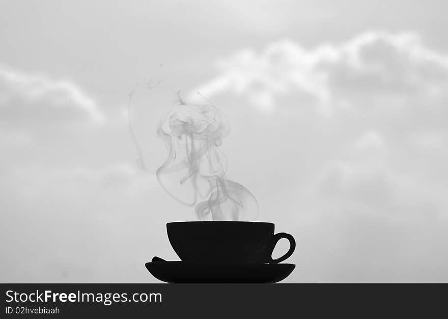 Black and white shot, big contrast, coffee cup on clouds background. Black and white shot, big contrast, coffee cup on clouds background