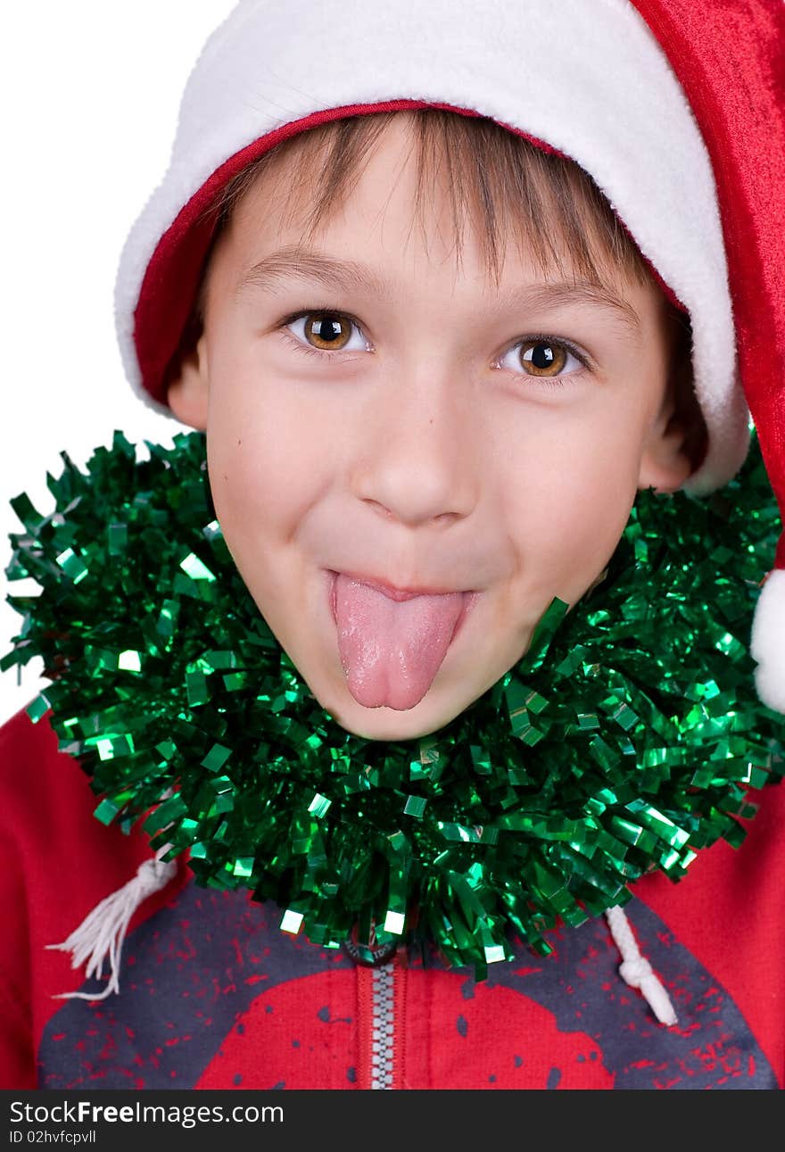 Cute small boy with santa's hat puts out the tongue isolated